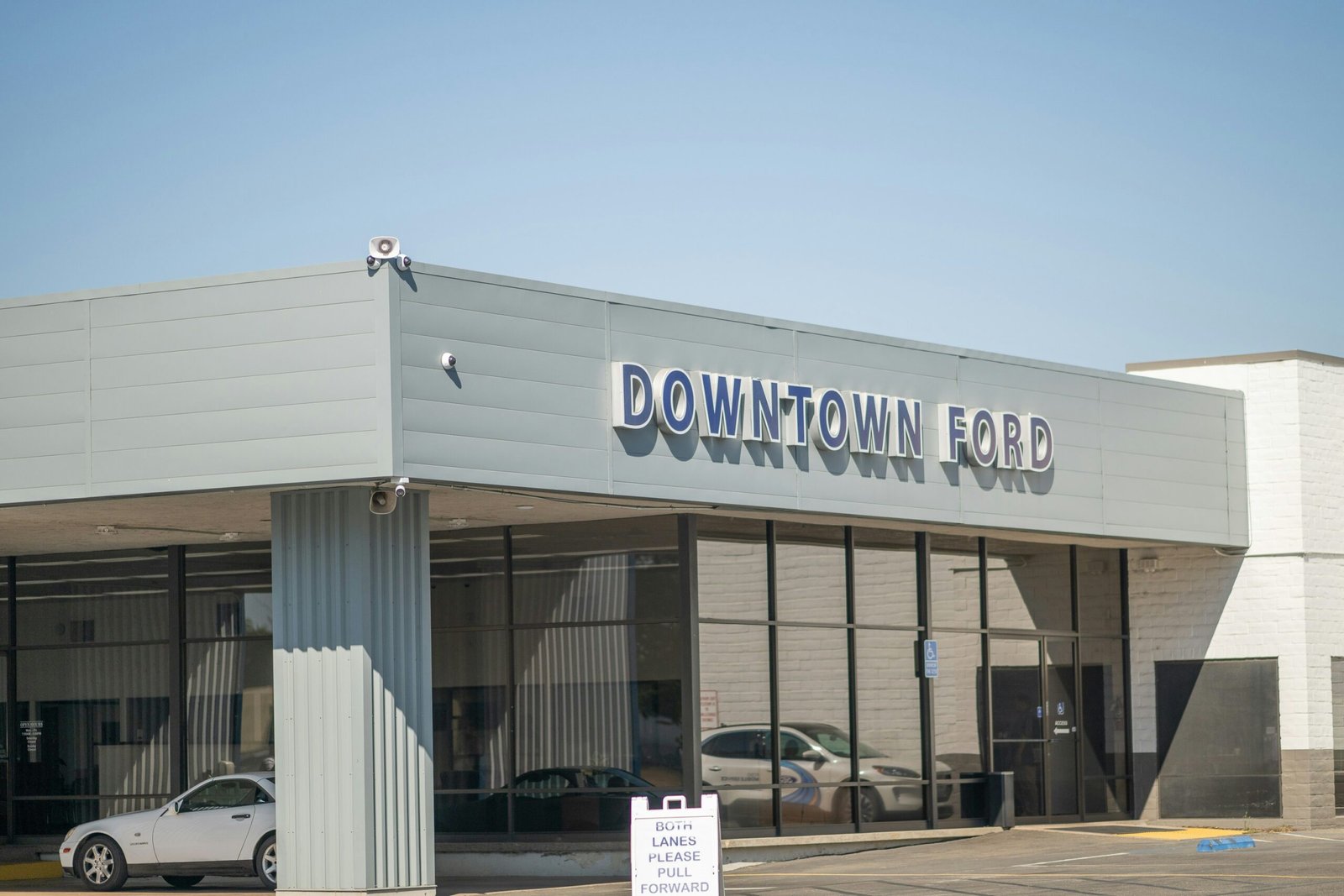 A car dealership with cars parked in front of it